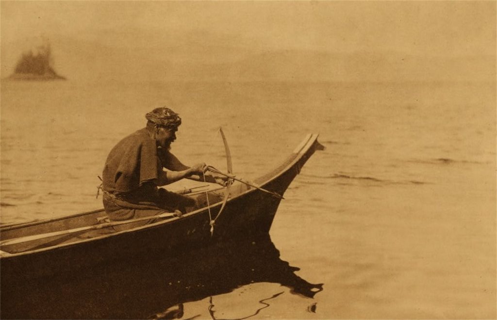A Nuu-chah-nulth hunter readies to kill a sea otter in 1915. Otter hunting has long been a Nuu-chah-nulth tradition and likely helped maintain healthy otter populations and sustainable fishing.
