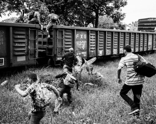 Central American men chase after a train departing from Pakal-Na. They are not aware that this train is being used as a trap by Mexican immigration officials. It will travel only a few kilometers before being stopped. An excerpt from one researcher’s field journal: “The train has been stopped. La migra is conducting a raid. We get to the train tracks and see that some migrants are able to flee. We see one agent hitting a migrant. Others are sitting down and bleeding from their heads. They will all be deported.”