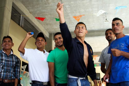 Although they are in the process of migrating, these migrants are not wholly defined by their participation in this clandestine activity. During their brief stays in this shelter in Pakal-Na, people find creative and resourceful ways to pass the time. This includes playing music, swapping stories, or, in the case of the men in the photo, inventing a game out of discarded plastic bottle caps. These diversions help take migrants’ minds off what has already happened to them or what lies ahead.