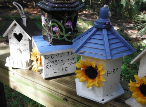 Occasionally, birdhouses do not occur alone, but rather appear in a series with a single meaning. These four birdhouses commemorate a marriage and the couple’s love.