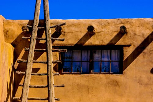 Pueblo Houses - One of the oldest inhabited communities in North America, Acoma is known as a “place that always was.” This pueblo rests atop a monumental 357-foot-tall mesa in western New Mexico. Today, the mesa holds approximately 300 adobe structures that house 30 Acoma religious leaders year-round. Other members of Acoma Pueblo live below in various satellite villages. Traditional ladders such as this one can see be seen around the pueblo.