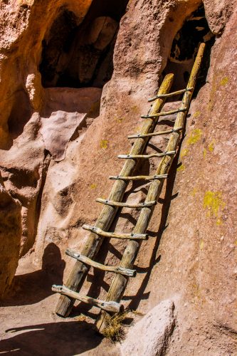Between A.D. 1150 and 1300, Ancestral Pueblo people migrated away from the Four Corners region and poured into Frijoles Canyon, building houses in naturally occurring cavities in the cliffs. These cave dwellings were only accessible by ladder. Today, the National Park Service has placed modern ladders outside some of these cavities, so visitors can enter the dwellings just as the Ancestral Puebloans would have done.