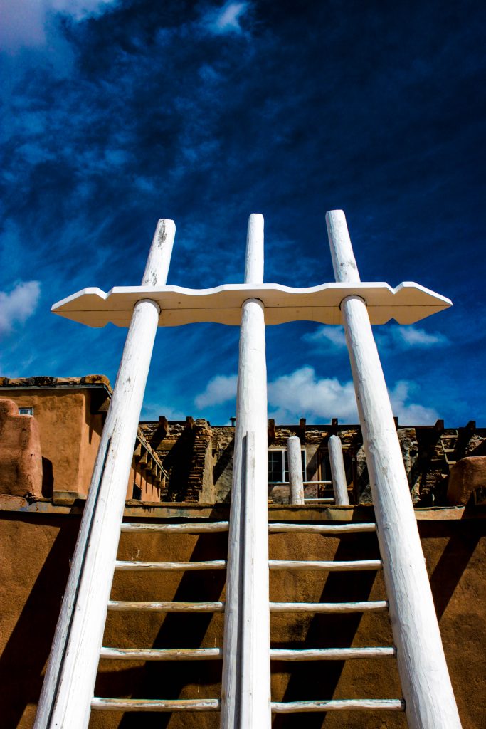 The ladder acts as a central axis holding the universe together. According to anthropologist Elsie Clews Parsons, for the Acoma, “the Earth Mother is held in position by the Galaxy arching overhead, and a stick-image of the Mother is called [a] center pole; it holds the four stratified skies and the four stratified earths together, so to speak, a pole of gravity.”