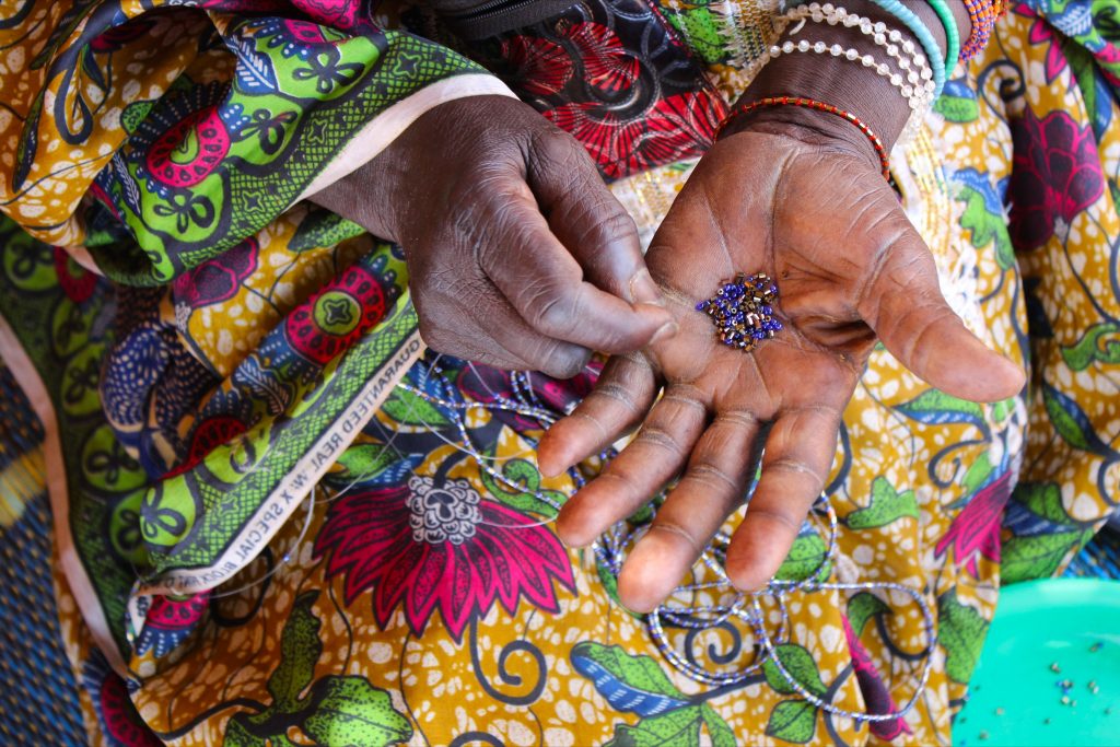 Stuck at fistula centers without family, farming, cooking, and other responsibilities, women often have very little to do. Without a scheduled appointment for surgery, women pass the months on hospital grounds tending to their hygiene, braiding each other's hair, and making bracelets to sell outside the hospital walls for 5 CFA (about one U.S. penny) apiece—their only source of spending money.
