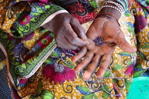Stuck at fistula centers without family, farming, cooking, and other responsibilities, women often have very little to do. Without a scheduled appointment for surgery, women pass the months on hospital grounds tending to their hygiene, braiding each other's hair, and making bracelets to sell outside the hospital walls for 5 CFA (about one U.S. penny) apiece—their only source of spending money.