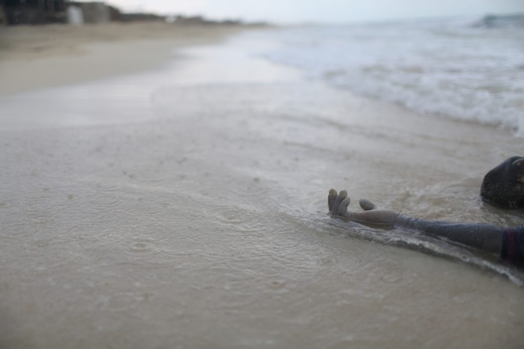 In 2015, over 3,770 migrants and refugees died while crossing the Mediterranean Sea, making it the deadliest year on record. This fact is grimly illustrated in this image of a body tragically washed ashore at Zuwara, Libya.