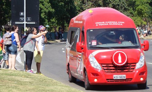 Olympic festival -- A van from Coca-Cola, one of the torch relay's corporate sponsors, leads the way and offers spectators free bottles of Coke. The torch relay is the only event that the International Olympic Committee (IOC) does not control and, unlike in the sport venues where advertising is not allowed, the torch relay is hyper-commercialized.