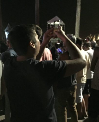 Olympic festival -- Many spectators were sandwiched between two virtual realities—the giant screens and their smartphones.