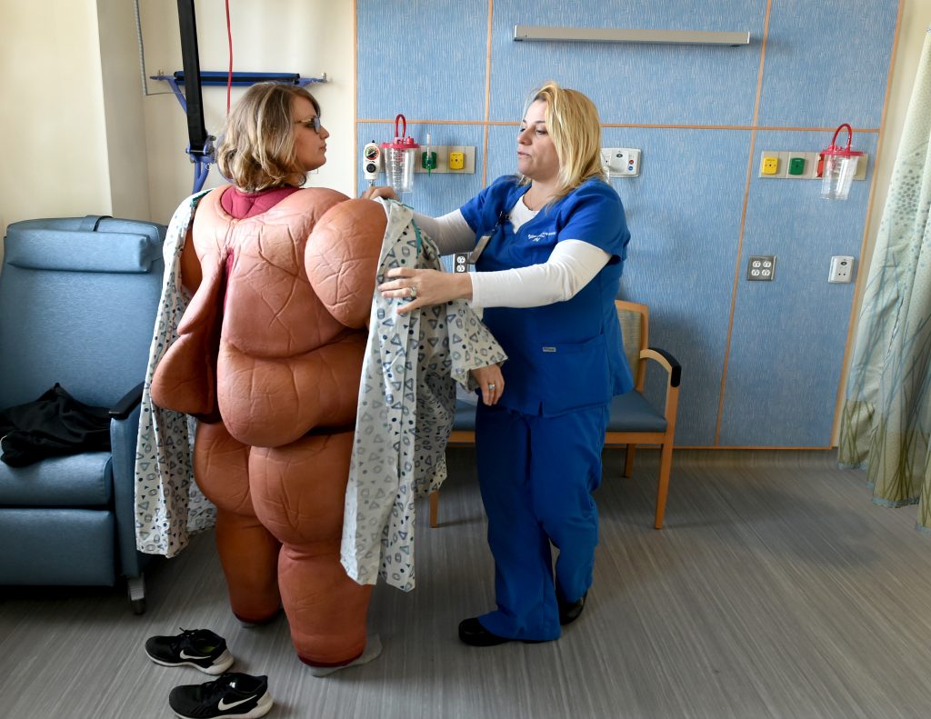 A nurse in a bariatric surgery unit tries on a fat suit to simulate the experience of her patients. As blame and shame around excess weight have become more common, so too have surgical weight-loss procedures.