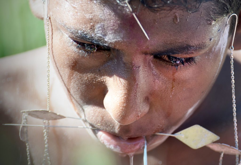 A Tamil boy in Mauritius stoically endures the pain of multiple piercings in his body—because that’s what men do. Rites of passage often mark the transition from childhood to adulthood. Psychological research shows that undergoing an unpleasant initiation in order to join a group increases a person’s liking for that group, as initiates feel a need to justify their ordeal.