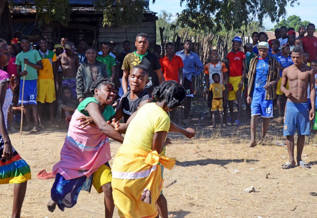 Two girls in Madagascar fight while villagers look on. In this ritual, participants are grouped by age and gender and paraded in front of the crowd. Anyone can challenge a competitor in the same group by looking into his or her eyes. Once a fight is accepted, the combatants throw punches at full strength until an arbiter breaks the fighters up. Although battles are fierce, there is usually no resentment among opponents after the games. Such rituals allow people to vent steam in a controlled and socially acceptable way. Some highly ritualized sports (think of martial arts) may serve a similar function.
