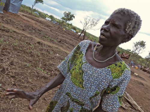 Katarin Ladu, a South Sudanese refugee living in a settlement called Pagirinya in northern Uganda, stands on the small plot of land where she is trying to grow pea leaves. Like hundreds of thousands of others, she primarily subsists on World Food Program rations of maize, beans, sorghum, and other staples.