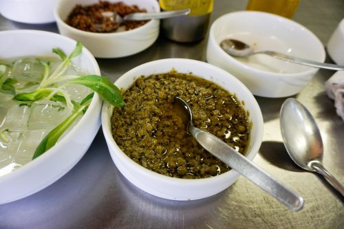 Capers soak in herb-infused oil, baby arugula rests over ice, and red pasankalla quinoa sits after being boiled in grape juice extract.