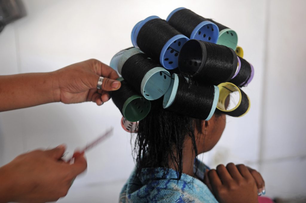 dominican salon - A 12-year-old girl has her hair straightened at a beauty salon in Boca Chica, Dominican Republic.
