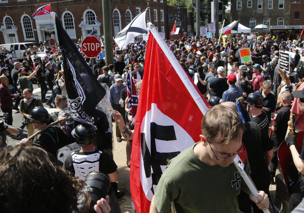 charlottesville violence - On August 12, this white supremacist protester entered Emancipation Park, where the Lee statue stands, holding a Nazi flag.