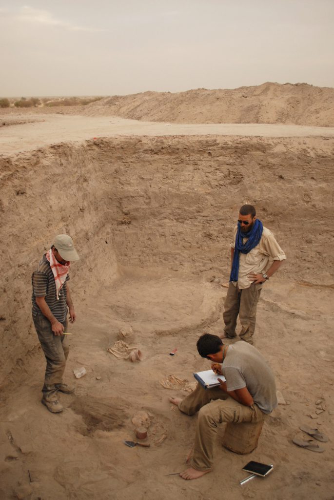 The author, in the blue scarf, along with two colleagues, investigates ancient ruins about 6 miles south of Timbuktu.