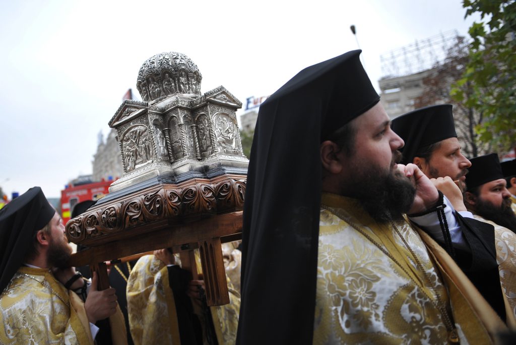 gift wrapping reason - Romanian Orthodox priests carry the reliquary containing the head of St. Andrew during a religious procession toward Romanian Patriarchy Cathedral, in Bucharest, on October 24, 2011.
