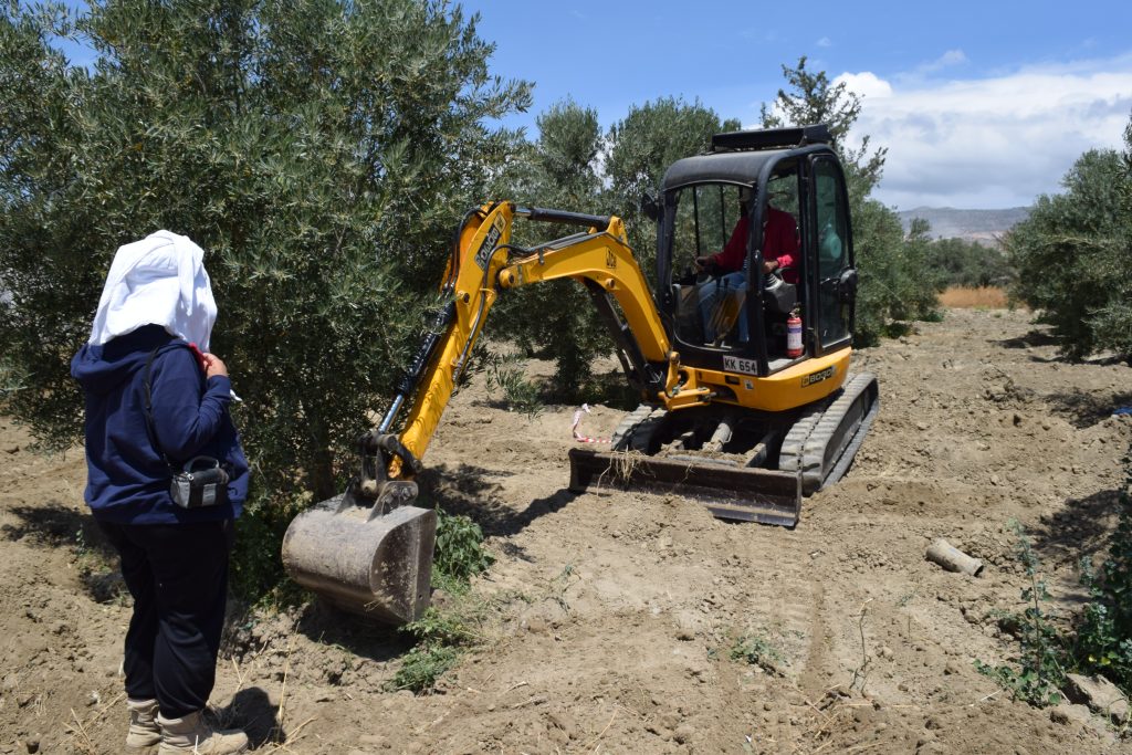 A backhoe excavates a site.
