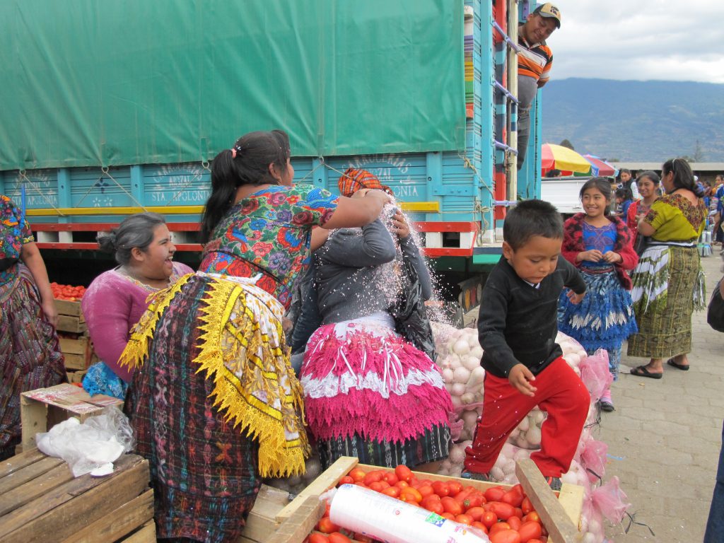 A group of hard-working young market traders in Antigua, Guatemala, take a break to smash cascarones over each other’s heads.