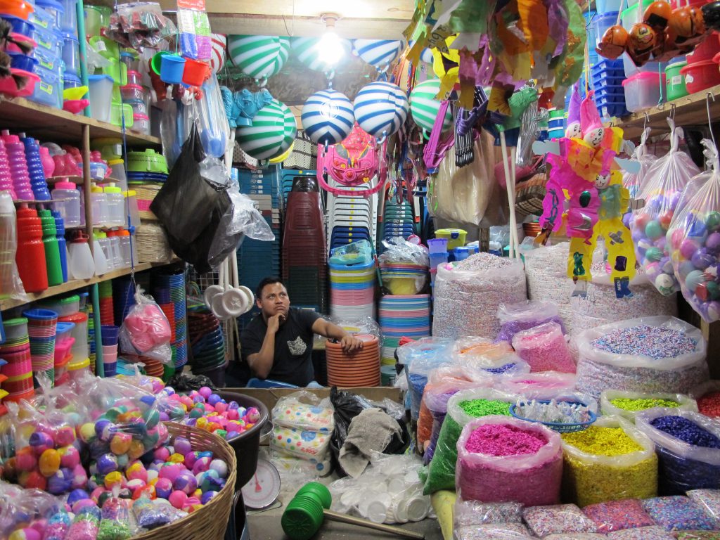 Cascarones and pica-pica sometimes nearly fill up an entire shop. Note the dolls hanging on the right side of the photo, which show how elaborate cascarones can get.