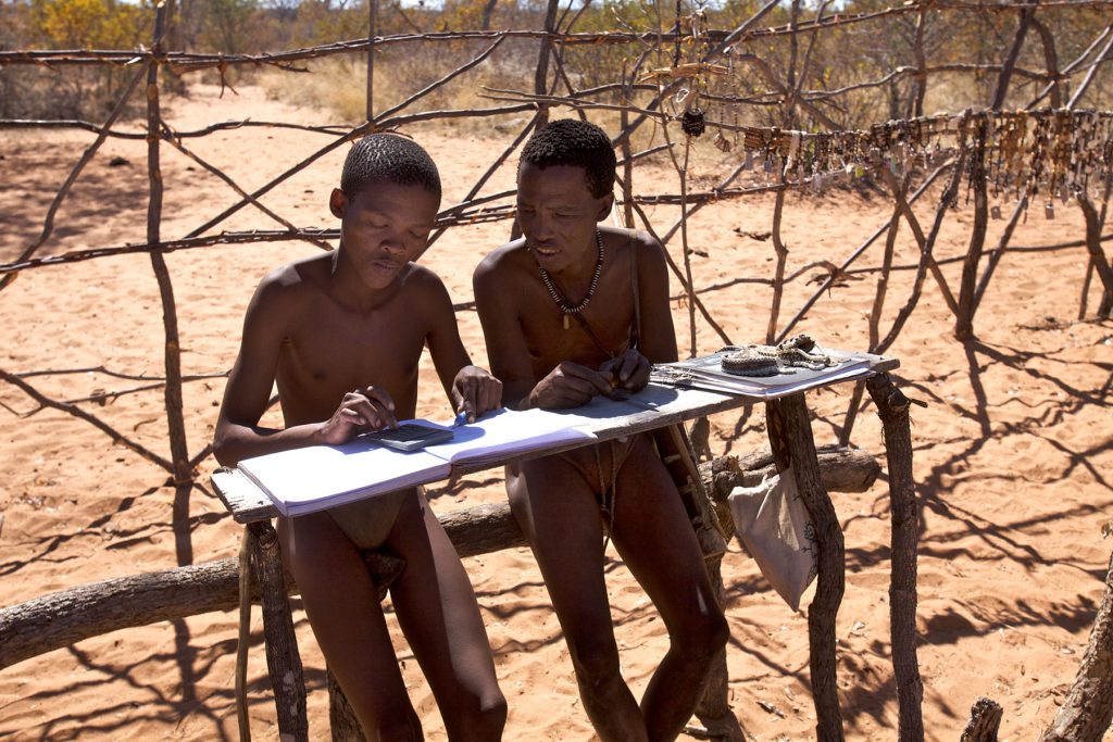 These Ju/’hoansi men are working in a handcrafted-jewelry market stall in Tsumkwe, Namibia.