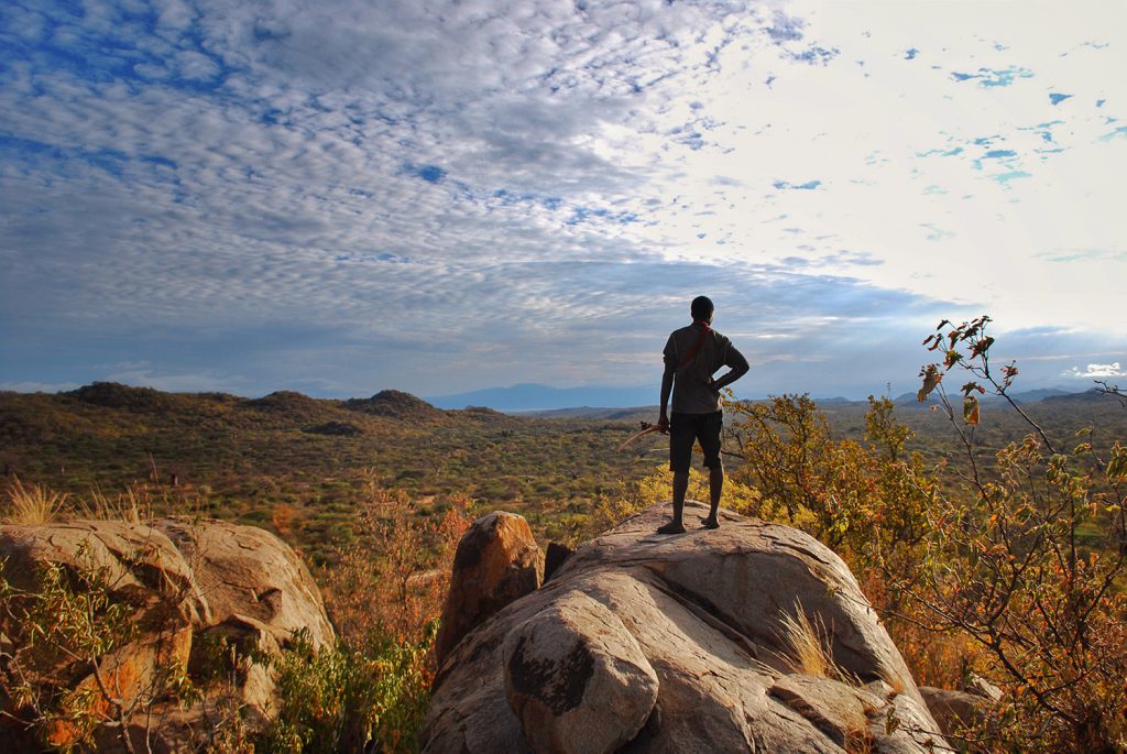 table manners - The vista from a rock mound in north-central Tanzania is often enjoyed by groups of Hadzabe people.