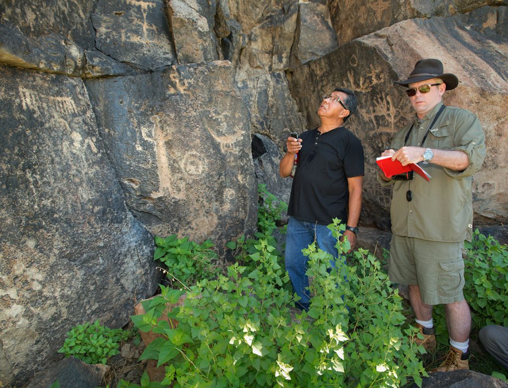 Author Steve Nash and Zuni cultural advisor Octavius Seowtewa inspect the Tularosa rock art panel in 2015.