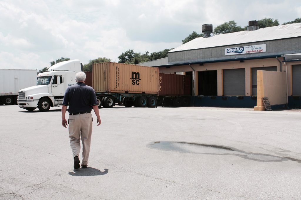 Bill walks toward a warehouse that offers storage space and distribution services. This is the kind of business Arthur considers a “passive industry.”