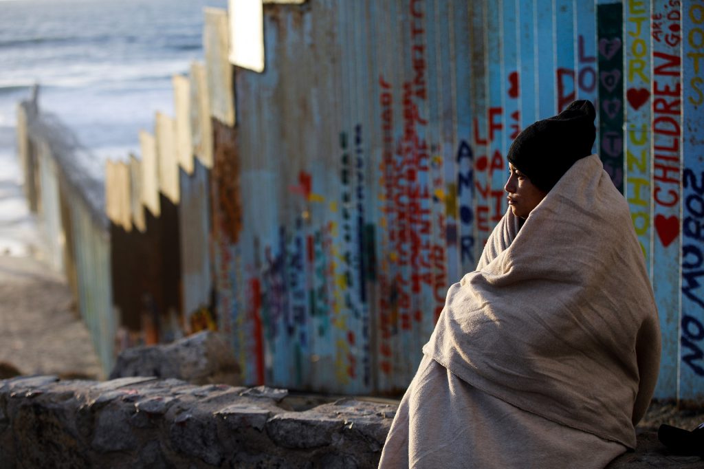 anthropology news - A small migrant caravan that set off on foot from Honduras for Mexico and the U.S. in early October eventually grew to 7,000 people, largely from Central America. Here, a Guatemalan migrant woman rests in front of the U.S border fence at Playa de Tijuana in Mexico, where thousands from the caravan now await an opportunity to seek asylum in the U.S.