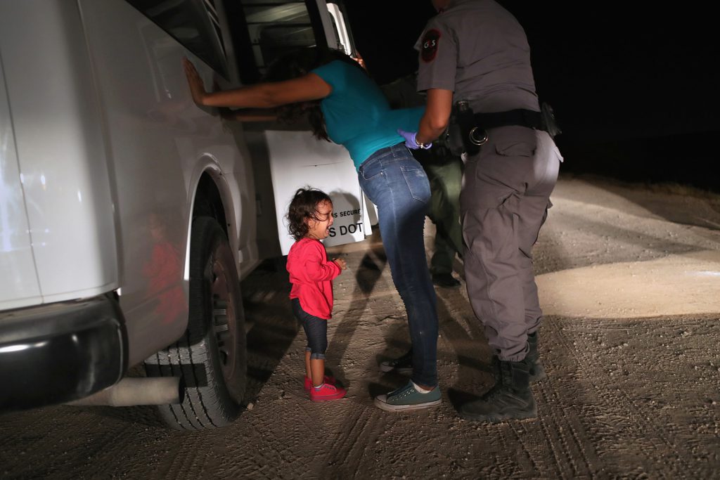 A 2-year-old Honduran asylum-seeker wails as her mother is searched and detained near the U.S.-Mexico border in Texas in June. A new “zero tolerance” policy toward undocumented migrants has led to tens of thousands of arrests, a family separation crisis, and the detention of 14,700 children.