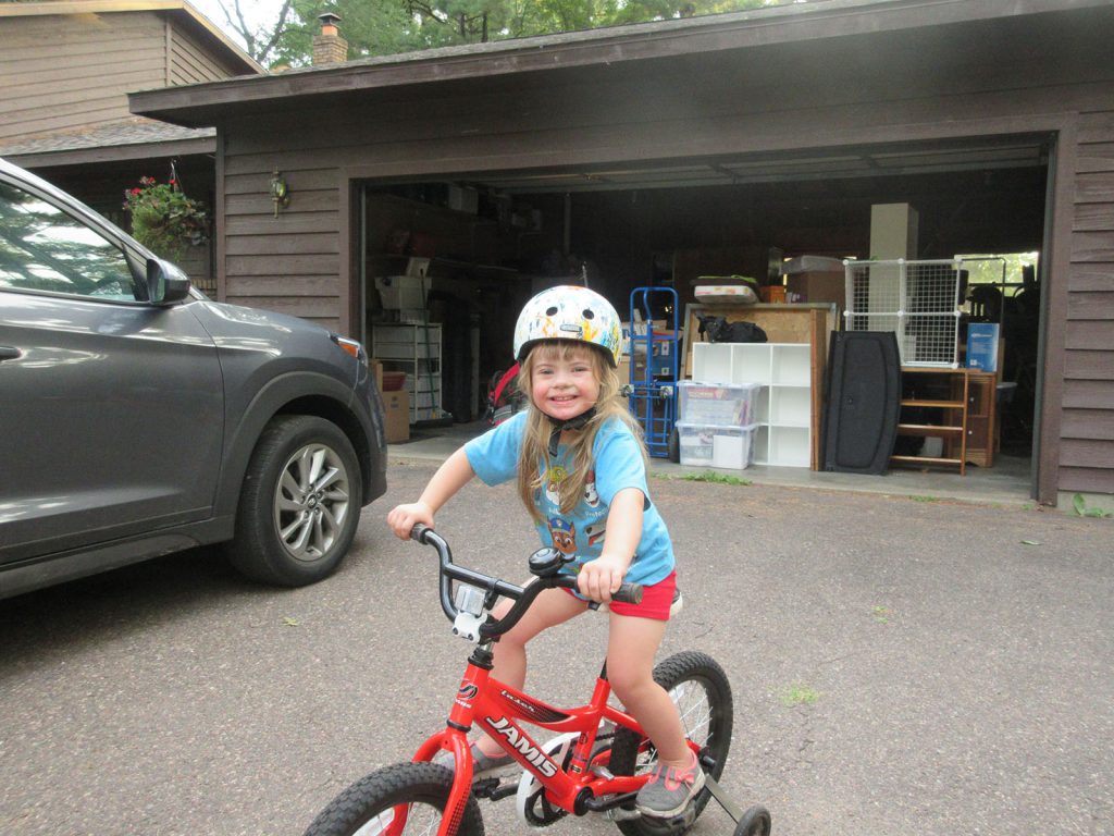 Michaela riding her bike in the summer of 2018, when she was 3.