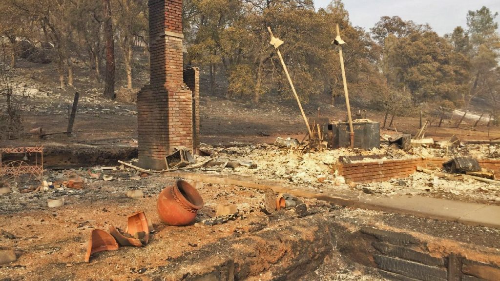 A house lays in burnt ruins after a fire.