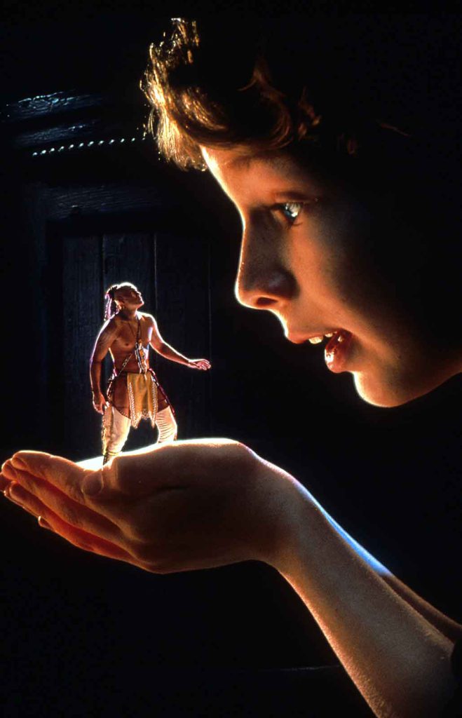 The young protagonist in the film The Indian in the Cupboard holds Litefoot, his Native American warrior friend.