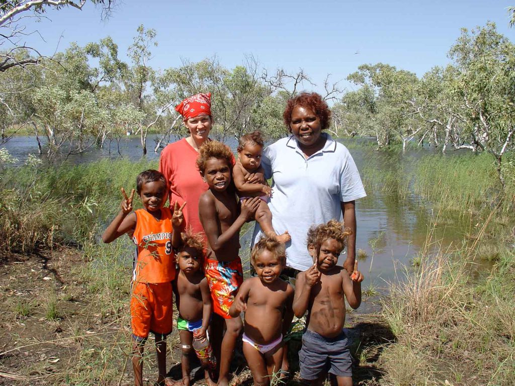 Linguist Carmel O'Shannessy (left) with Grace White Napaljarri (right) and children in her extended family, near their hometown of Lajamanu, in Australia's Northern Territory.