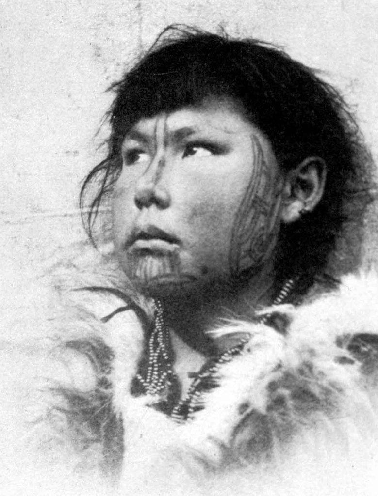 A Yupik woman, photographed in the early 1900s, bears traditional skin-stitched facial tattoos.