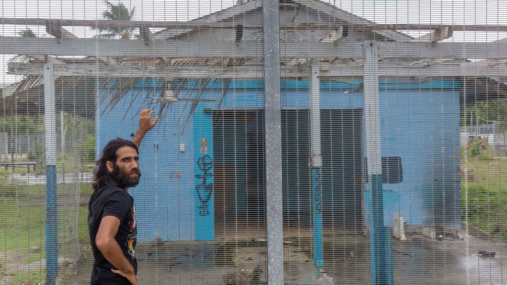 Asylum-seeker Behrouz Boochani stands near the abandoned naval base on Manus where he was imprisoned during the first three years of his exile on the island.