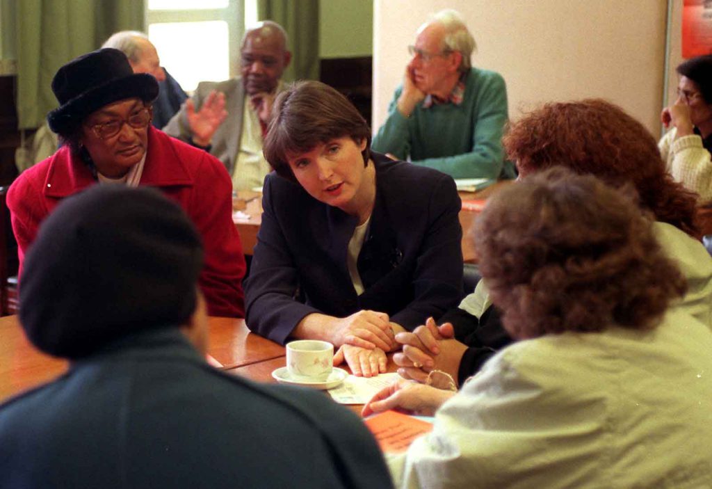 Social Security Secretary Harriet Harman talks with U.K. pensioners in 1998 who were among the first to receive winter fuel payments from the government.