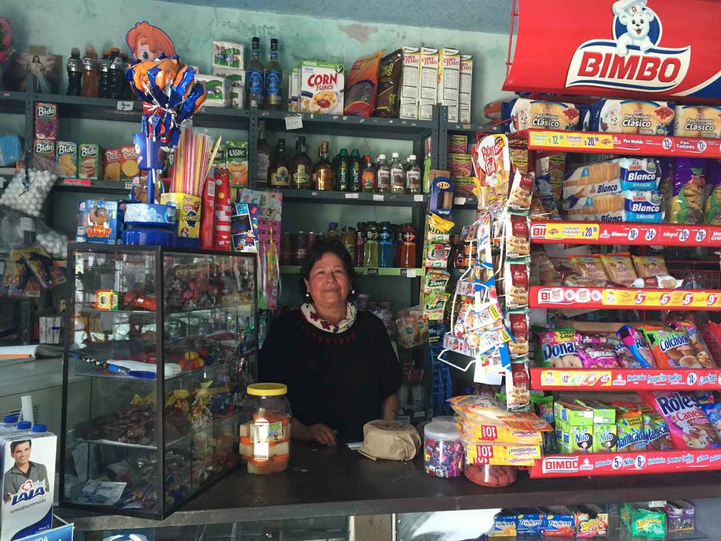 The proprietor of a small shop in the state of Puebla, Mexico, says she is obliged by distribution systems to sell processed snack foods.