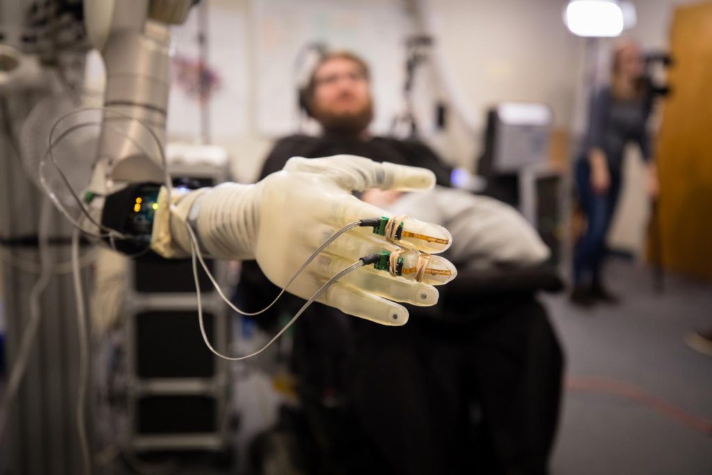 New technologies bring a sense of touch to paralysis patients through the use of a mind-controlled robotic arm.