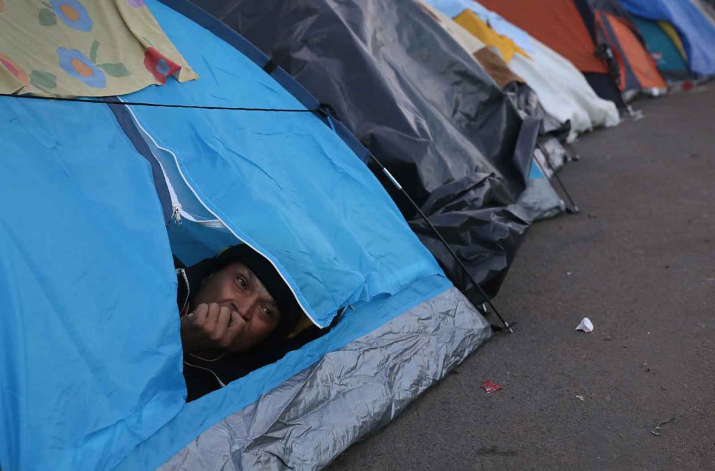 As migrants and asylum-seekers the world over struggle to find safety and new homes, temporary camps have sprung up in cities and along borders—such as this one in Tijuana, Mexico, where many Central Americans live in limbo.