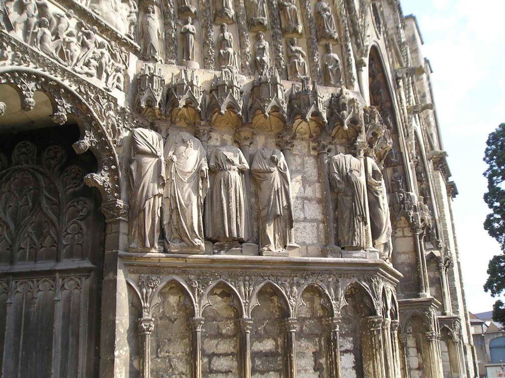Statues stand with their heads removed at the Cathédrale Saint-Étienne de Bourges, France.