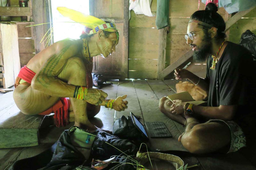 Anthropologist Manvir Singh (right) speaks with an Indonesian shaman (left).