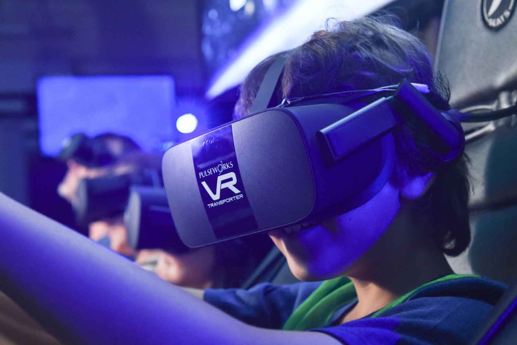 A young visitor at the Denver Museum of Nature & Science's virtual reality arcade experiences a simulated tour through space.