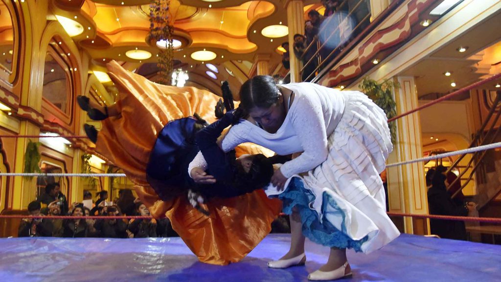 Martha La Alteña (right) and Susana La Bonita (left) wrestle in El Alto, Bolivia.