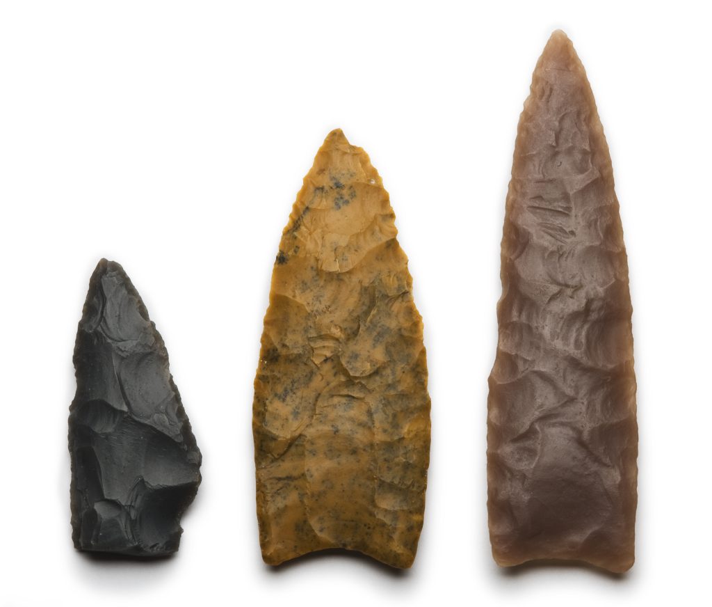 For decades, archaeologists associated finely fluted spear points—such as the two points at right—with the first people to live in the Americas.
