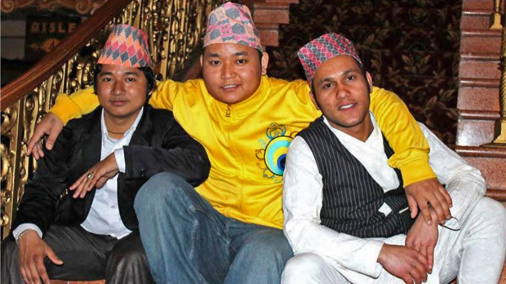 Bhutanese Nepali performers—including Shyam “San” Rai at center—pose at a cultural festival.