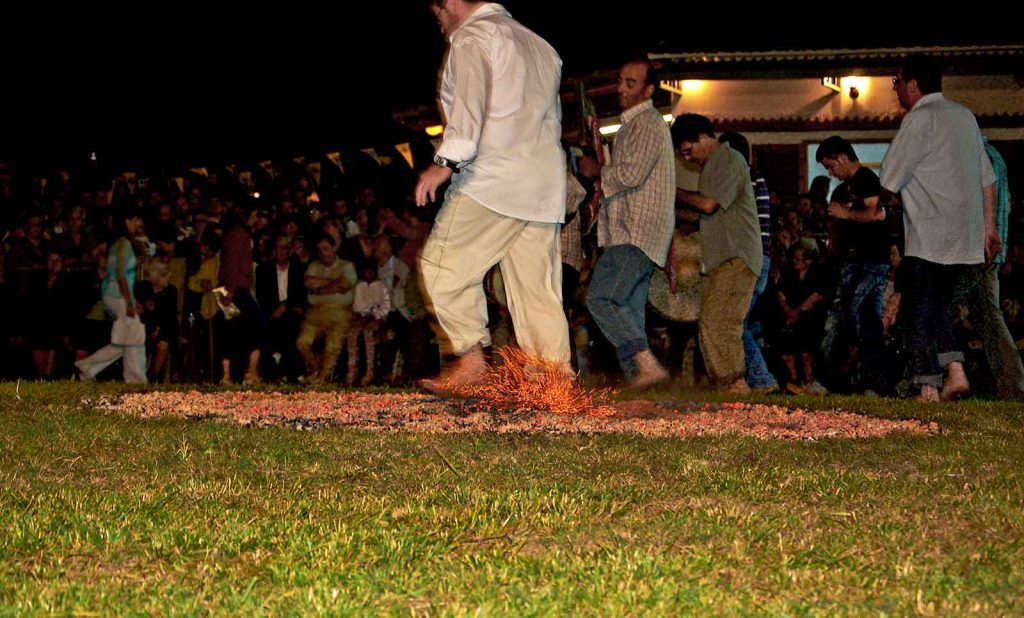People walk on burning coals as part of the tradition of Anastenaria in a northern Greek village.