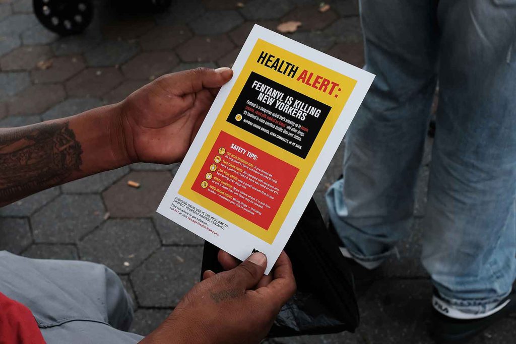 chronic pain - A heroin user in New York City reads an alert about fentanyl, which dealers often mix into other drugs, leading to an increased risk of overdose.