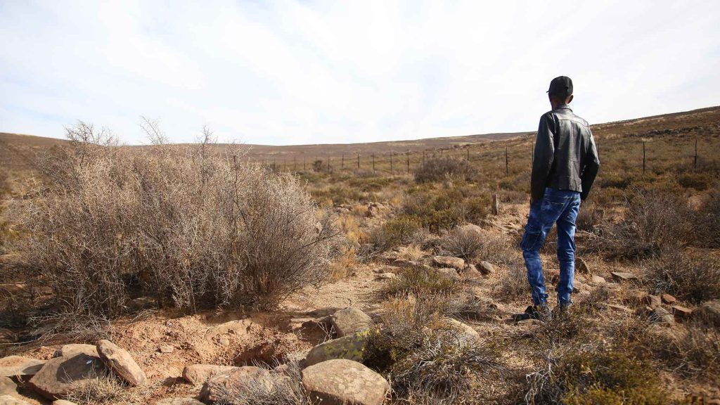 south africa repatriation - A man stands on the farm in Sutherland, South Africa, where a medical student once unethically exhumed nine bodies for scientific study.