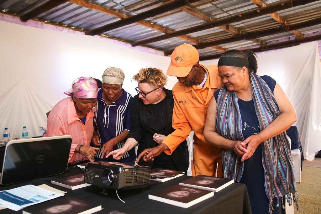 Descendants of the people whose remains had been removed from the Sutherland farm view facial reconstructions of their relatives with the guidance of Kathryn Smith (center), a doctoral student in forensic art.